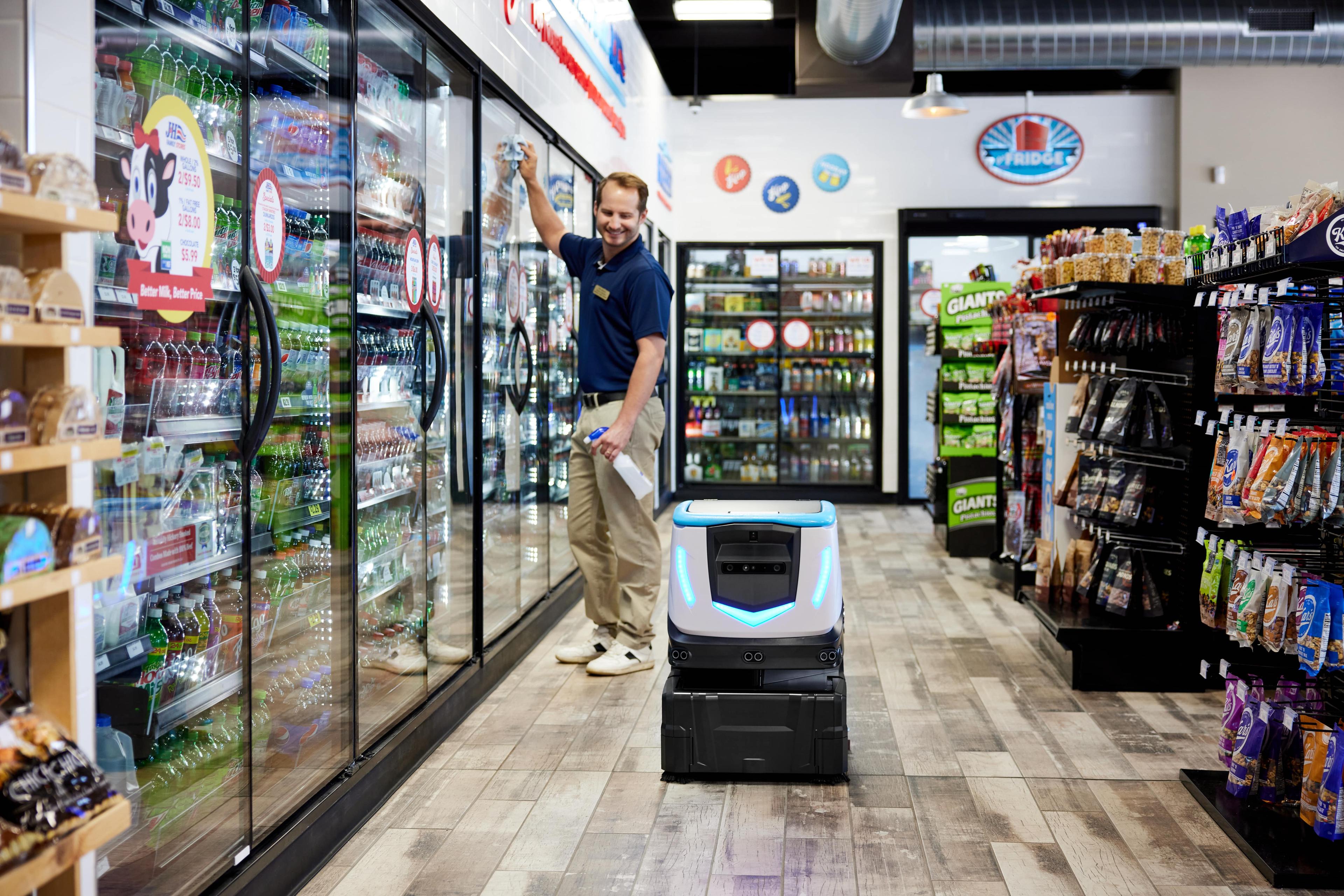 ICE Cobotics Cobi 18 working alongside a coworker in a convenience store