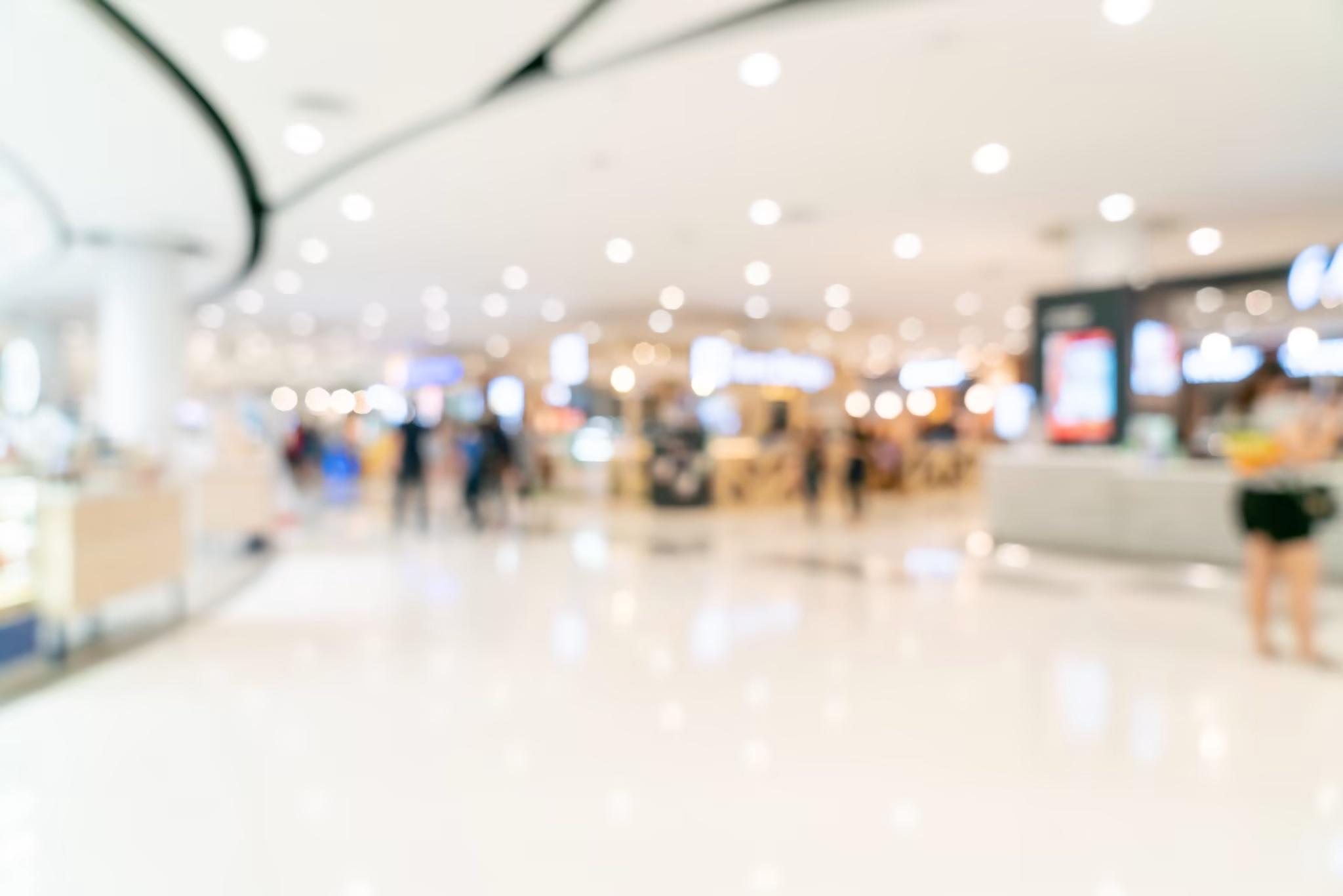 blurred out image of brightly lit shopping mall 